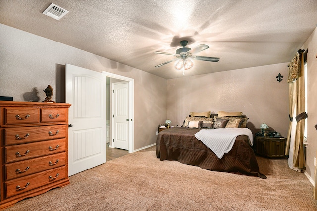 bedroom featuring carpet, a textured ceiling, and ceiling fan