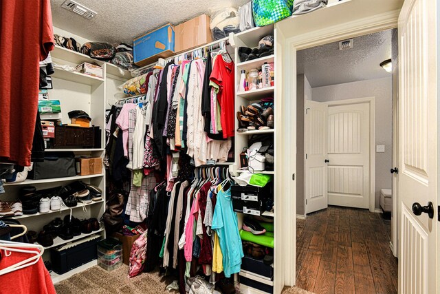 walk in closet featuring dark hardwood / wood-style flooring