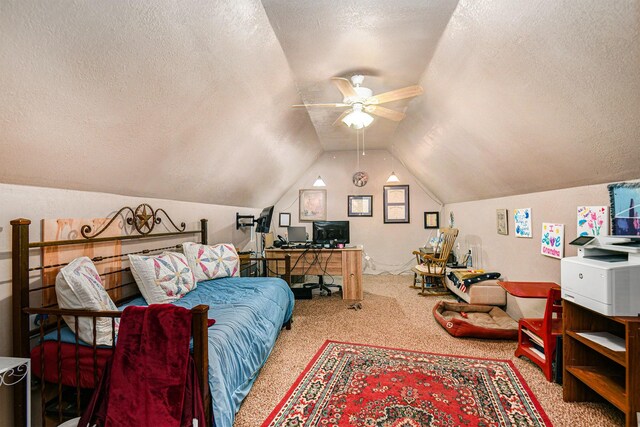 office area with ceiling fan, a textured ceiling, vaulted ceiling, and carpet flooring