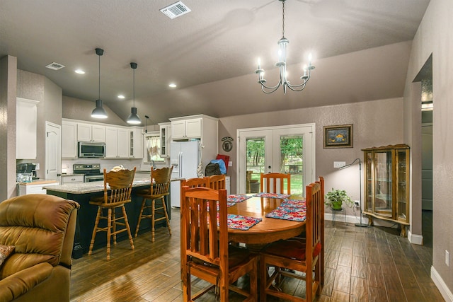 dining area with dark wood-type flooring, french doors, lofted ceiling, and a notable chandelier