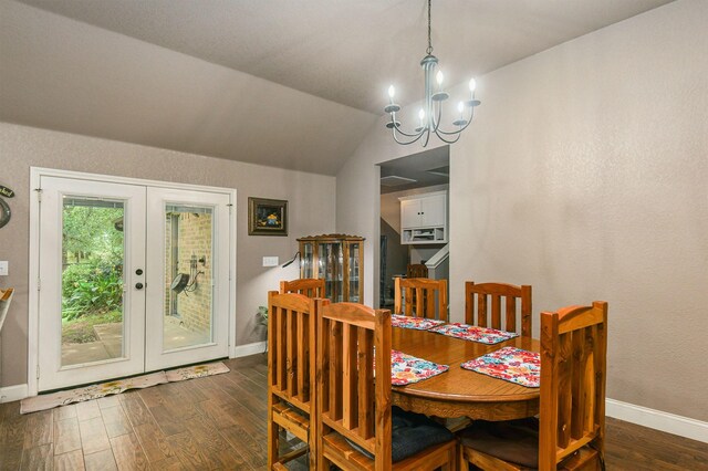 dining room featuring french doors, lofted ceiling, dark wood-type flooring, and an inviting chandelier