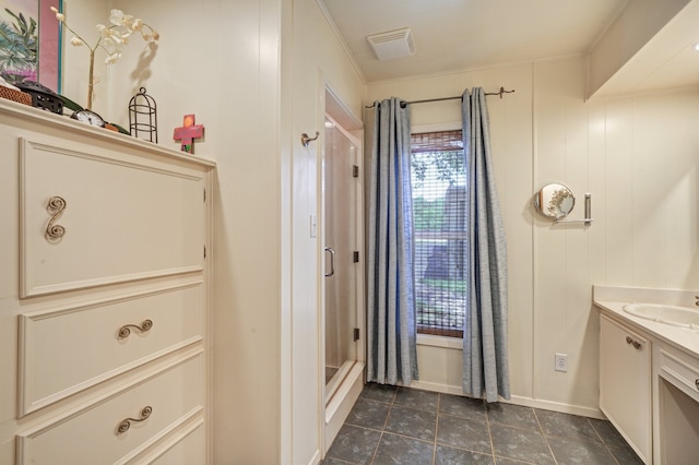 bathroom featuring ornamental molding, vanity, walk in shower, and wooden walls