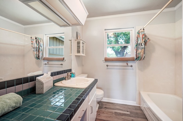 full bathroom with vanity, shower / bath combination with curtain, hardwood / wood-style flooring, toilet, and ornamental molding