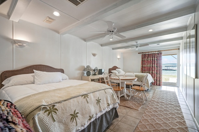 tiled bedroom featuring ceiling fan, beam ceiling, a water view, and access to outside