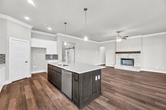 kitchen featuring dishwasher, a barn door, dark hardwood / wood-style flooring, and sink