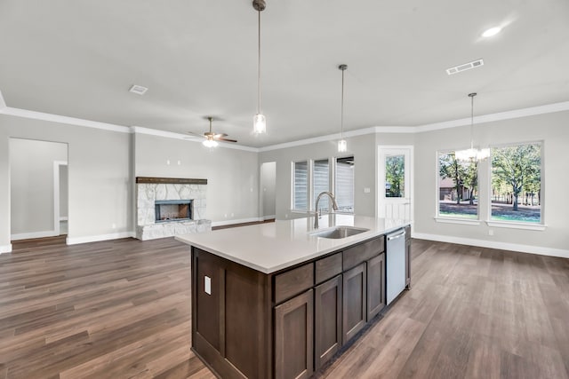 kitchen featuring sink, stainless steel dishwasher, dark hardwood / wood-style floors, crown molding, and pendant lighting