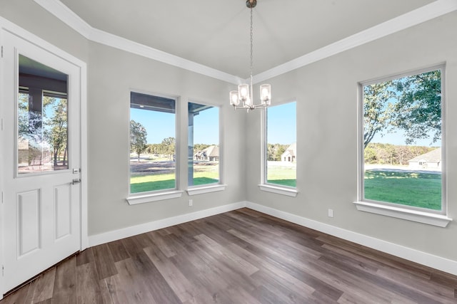 unfurnished dining area featuring hardwood / wood-style floors, a healthy amount of sunlight, and ornamental molding