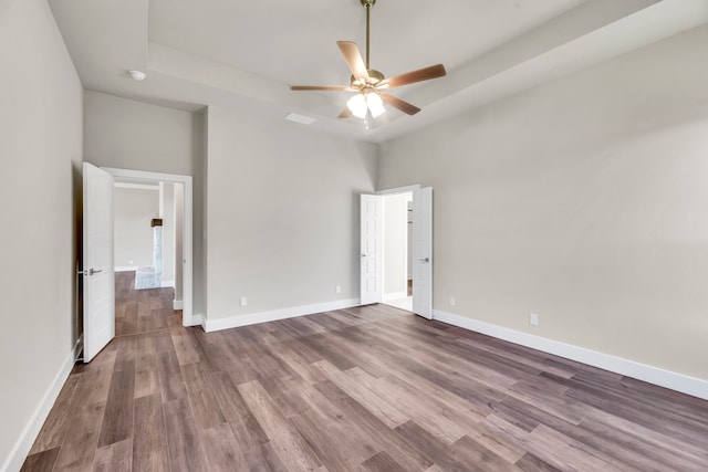 unfurnished bedroom with ceiling fan and wood-type flooring