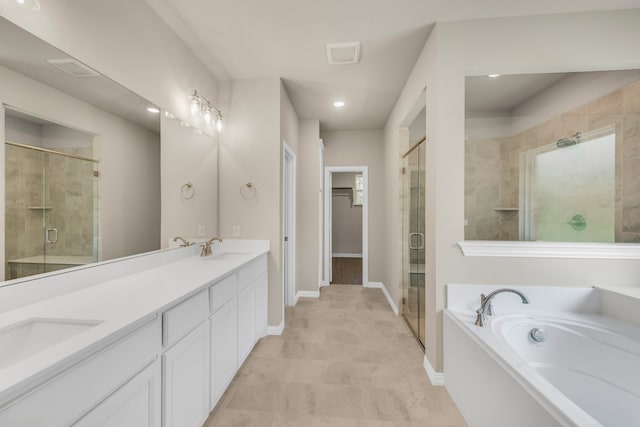 bathroom featuring vanity and separate shower and tub