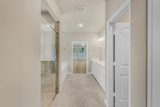 bathroom featuring vanity, tile patterned flooring, and separate shower and tub