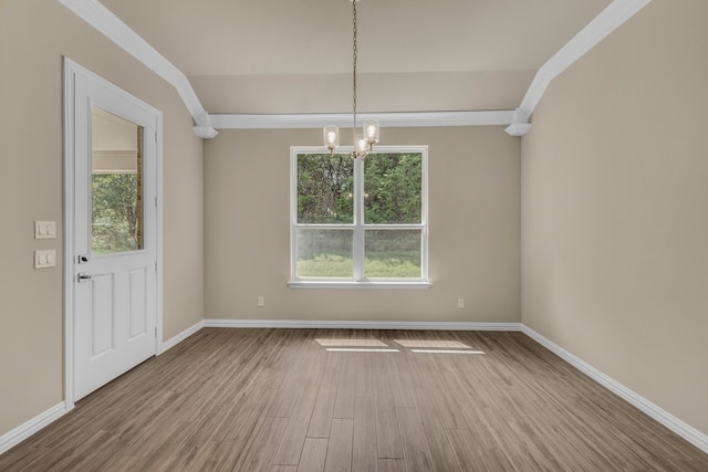 unfurnished dining area with an inviting chandelier, wood-type flooring, and plenty of natural light