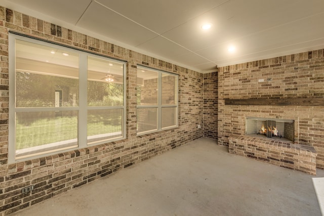 view of patio with a brick fireplace