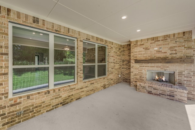 view of patio featuring a brick fireplace