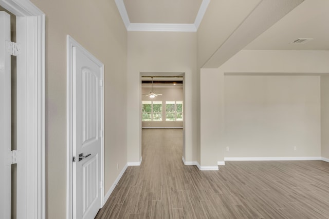 hall featuring wood-type flooring and crown molding