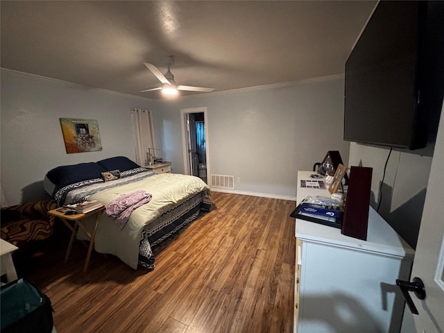 bedroom featuring ceiling fan, hardwood / wood-style floors, and crown molding