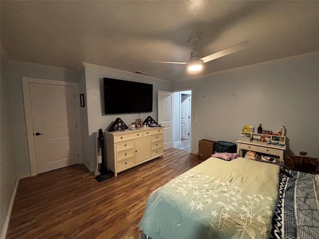 bedroom with ceiling fan, dark wood-type flooring, and ornamental molding