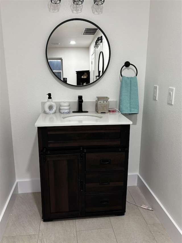 bathroom featuring tile patterned flooring and vanity