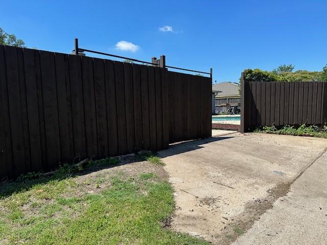 view of gate featuring a patio