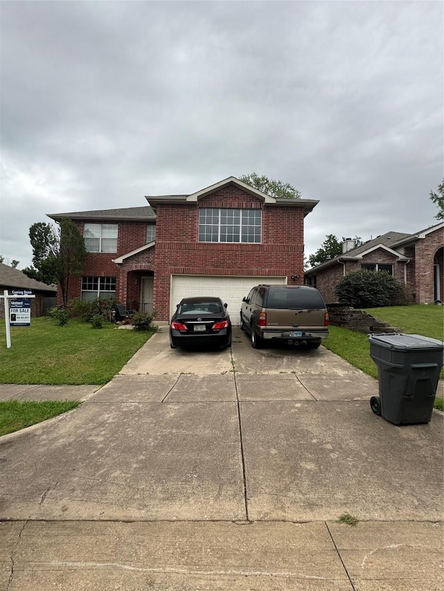 view of front of home featuring a front yard and a garage