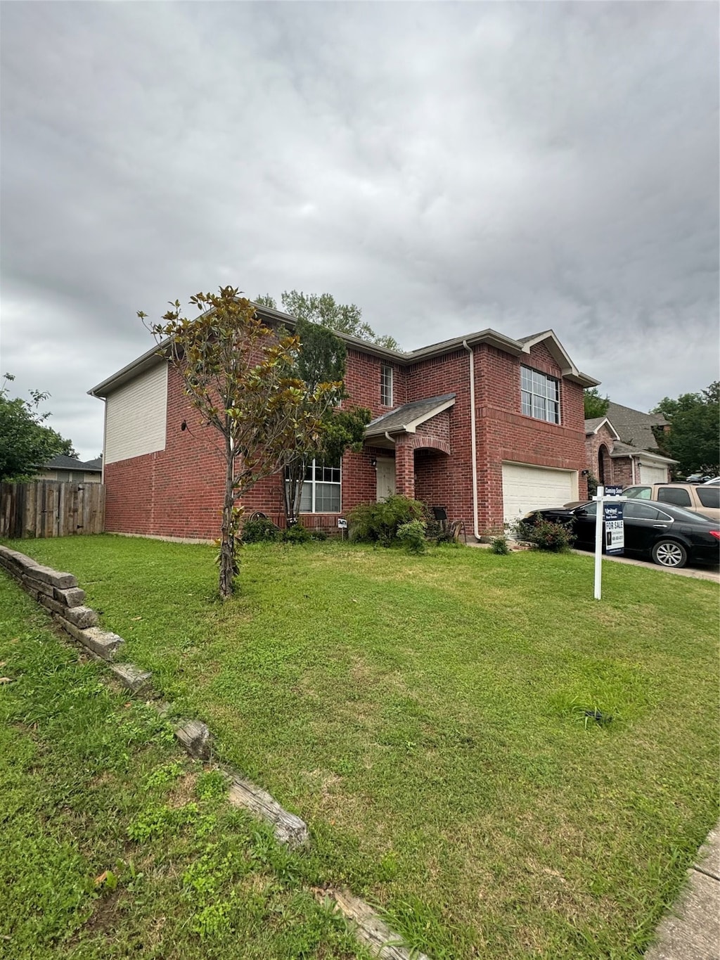 view of front of property featuring a garage and a front lawn