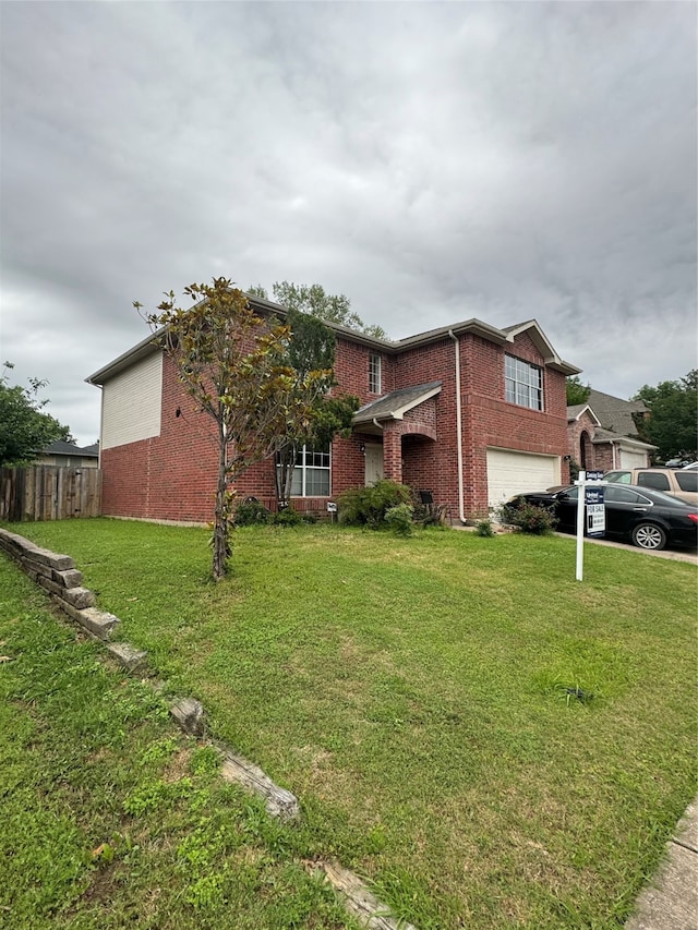 view of front of property featuring a garage and a front lawn