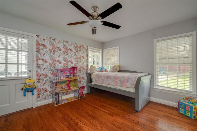 bedroom with ceiling fan and hardwood / wood-style floors