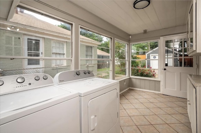 clothes washing area featuring separate washer and dryer and light tile patterned floors