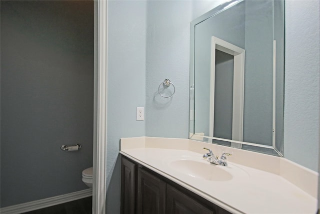 bathroom featuring vanity and toilet