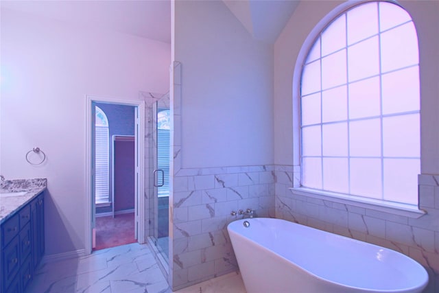 bathroom featuring vanity, lofted ceiling, plus walk in shower, and tile patterned flooring