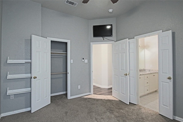 unfurnished bedroom featuring ceiling fan and light colored carpet