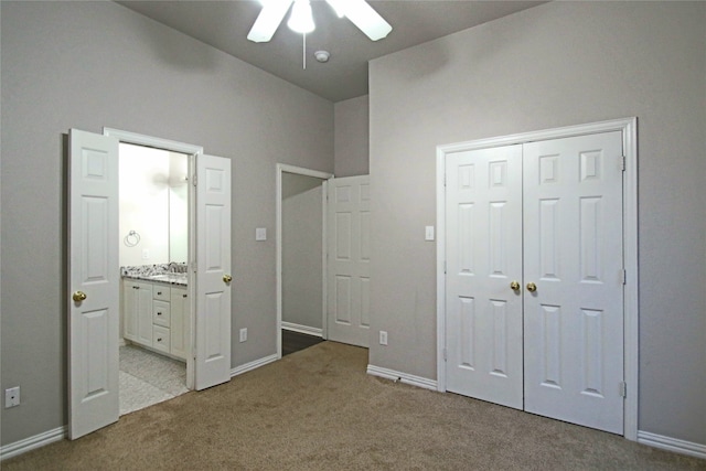 unfurnished bedroom with light colored carpet, sink, and ceiling fan