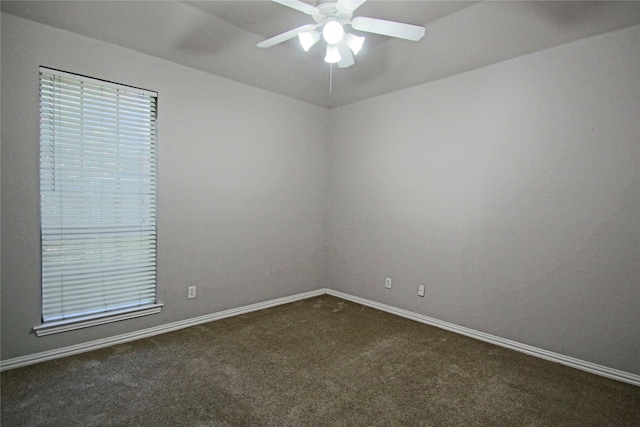 empty room featuring ceiling fan and carpet