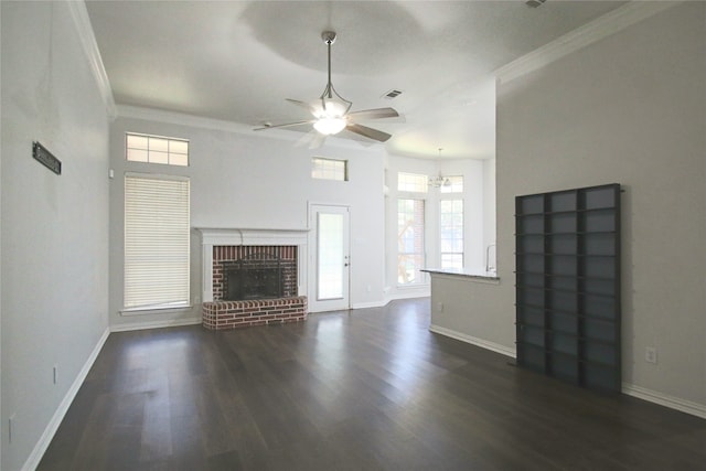 unfurnished living room with a brick fireplace, ornamental molding, dark hardwood / wood-style flooring, and ceiling fan