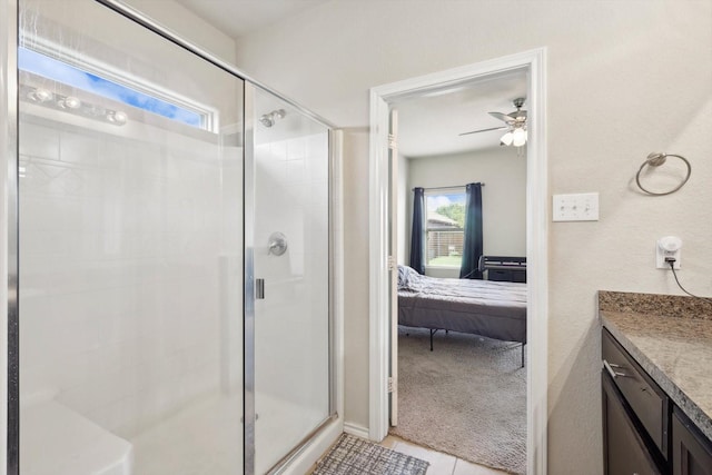 bathroom with ceiling fan, a shower with door, vanity, and tile patterned flooring