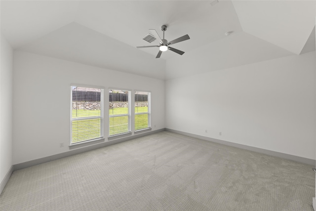 empty room with ceiling fan, lofted ceiling, and light colored carpet