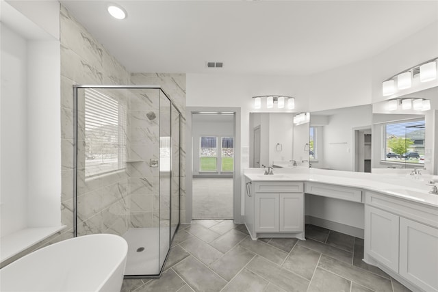 bathroom with independent shower and bath, tile patterned floors, and dual bowl vanity