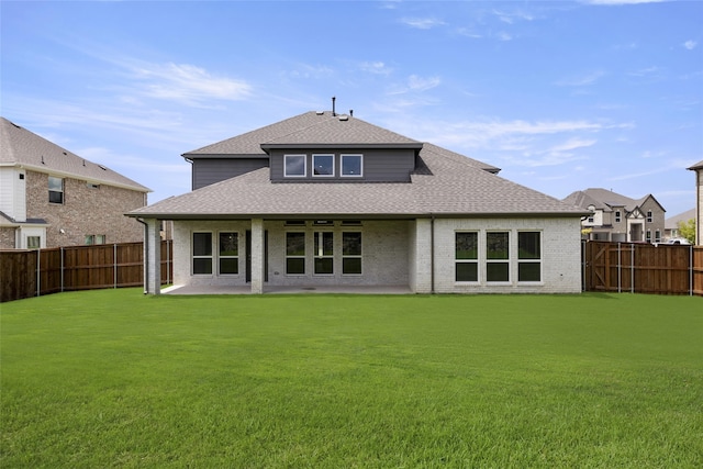 back of property with a patio and a yard