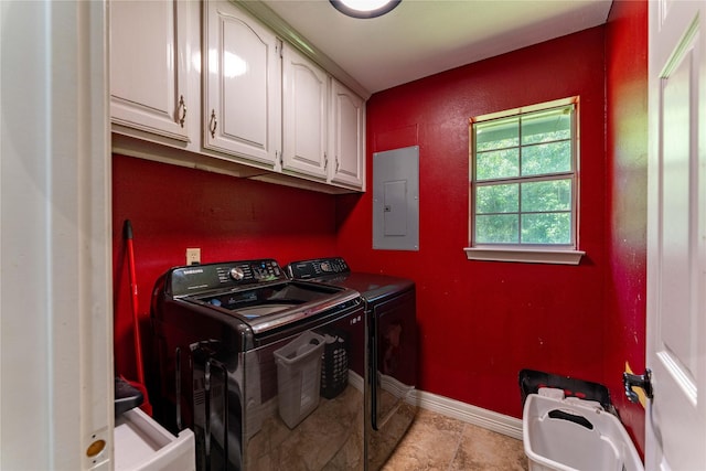 washroom with cabinets, washer and dryer, and electric panel