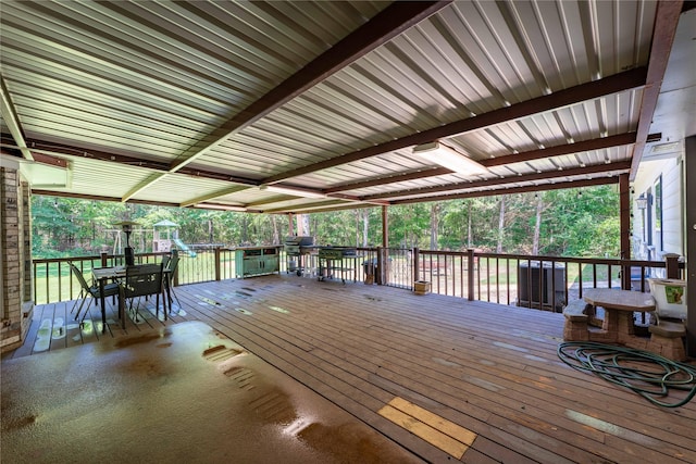 deck featuring grilling area and a playground