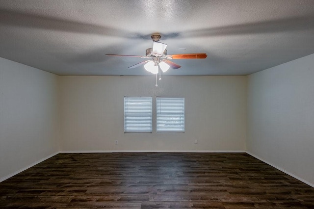 spare room featuring ceiling fan, dark wood-type flooring, and a textured ceiling