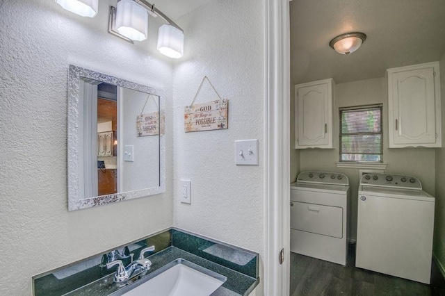 bathroom featuring hardwood / wood-style floors, vanity, and washing machine and dryer