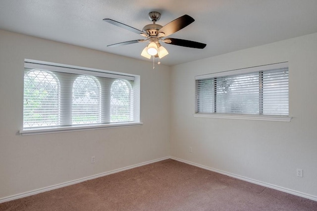 empty room with ceiling fan and light carpet