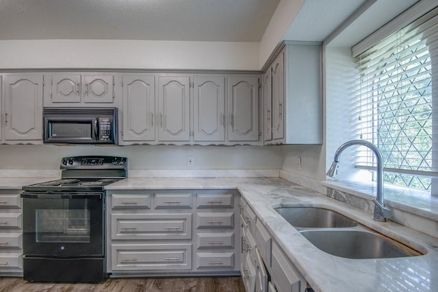 kitchen featuring sink, black appliances, and dark hardwood / wood-style floors