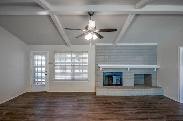 unfurnished living room featuring ceiling fan, dark wood-type flooring, beamed ceiling, and a fireplace