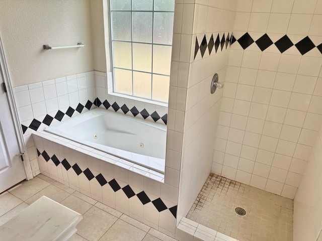 bathroom with tile patterned floors and independent shower and bath