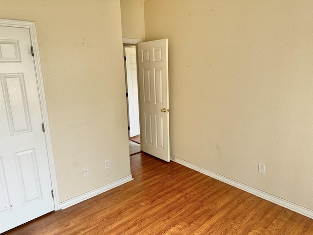 empty room with hardwood / wood-style flooring