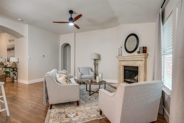 living room featuring wood-type flooring and ceiling fan