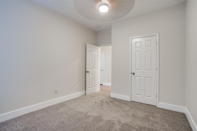 unfurnished bedroom featuring carpet flooring and ceiling fan