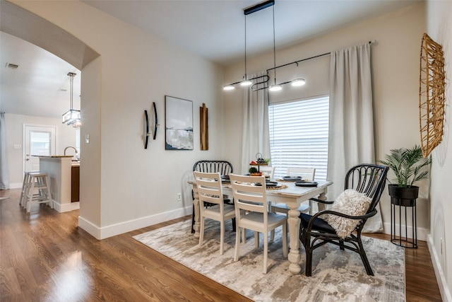 dining space with dark wood-type flooring