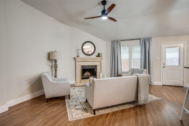 living room featuring hardwood / wood-style flooring, vaulted ceiling, and ceiling fan